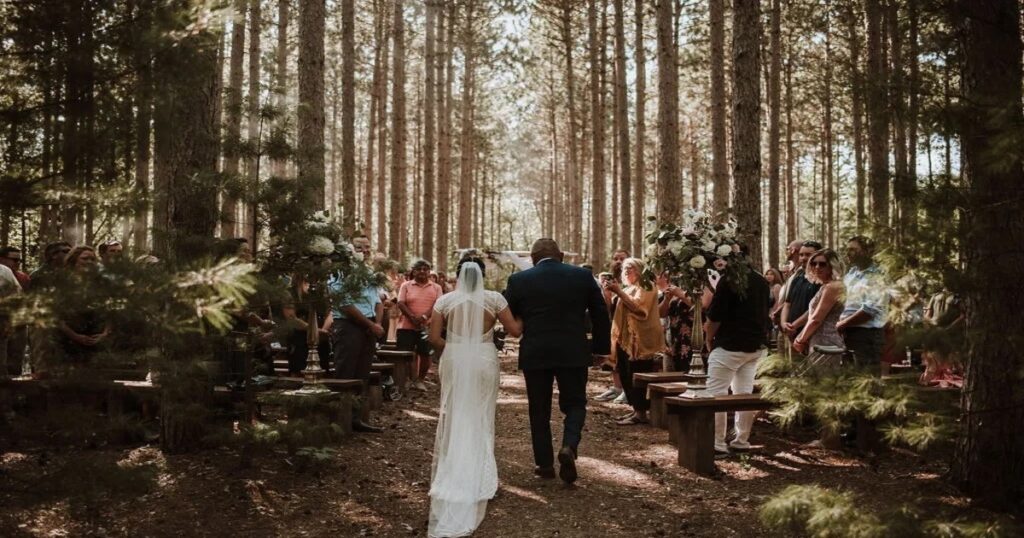 Looking for outdoor wedding venues in Wisconsin with a natural forest setting? Burlap & Bells features a pine grove aisle perfect for a woodland ceremony.